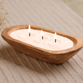 Ivory pearled candle wax in a wooden bowl with three lit wicks