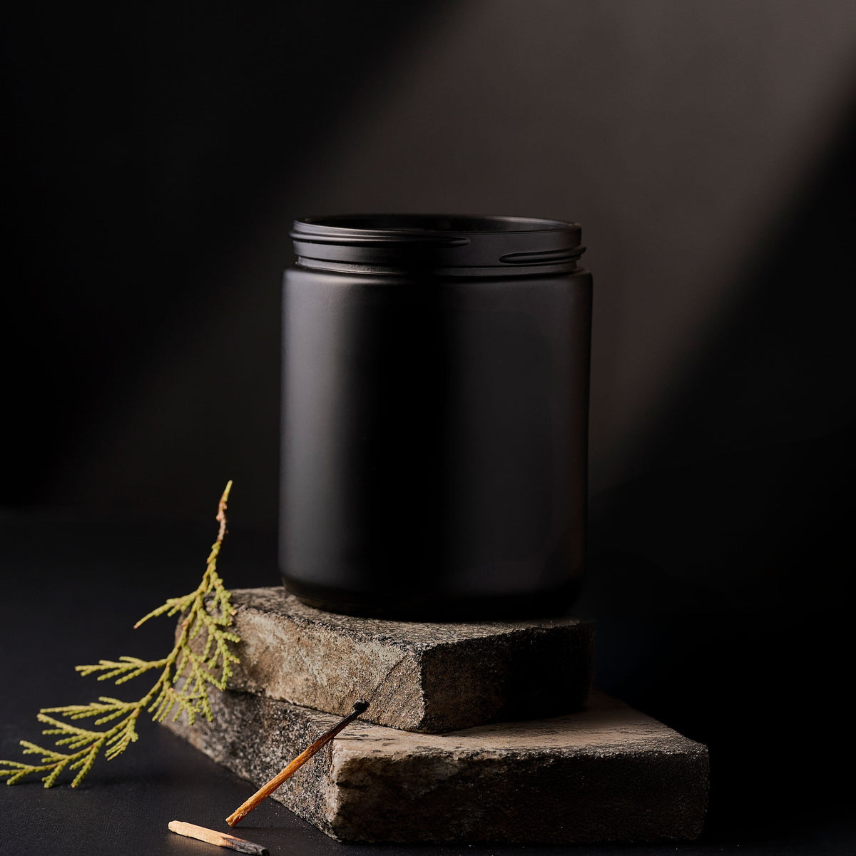 9 oz matte black straight-sided jar on a dark stone surface