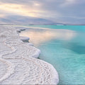 White salt-crusted shoreline by turquoise water