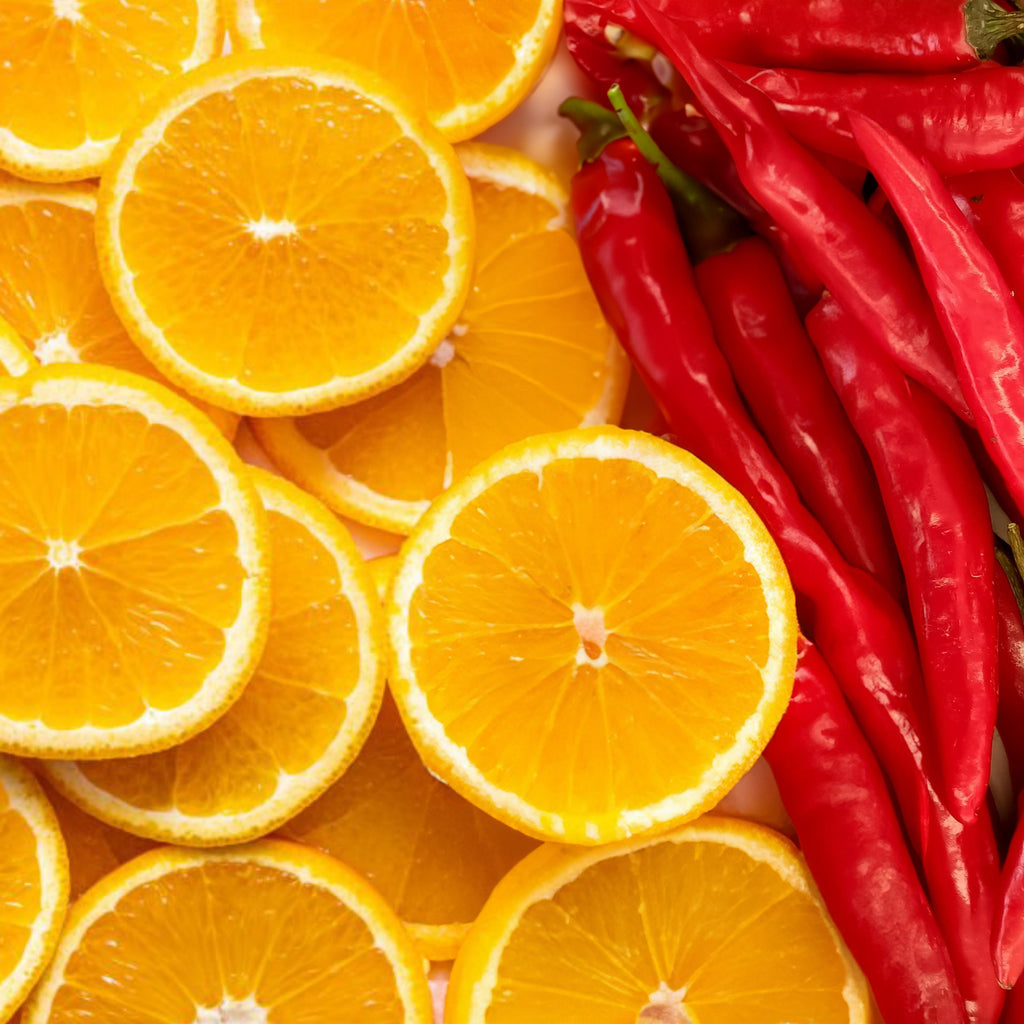 Sliced oranges and red chili peppers