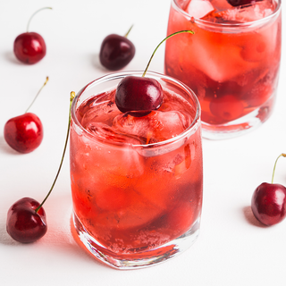 glasses of cherry punch topped with fresh cherries