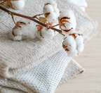 Cotton bolls on a soft folded white blanket