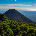 Volcanic mountain peak above a green tropical forest